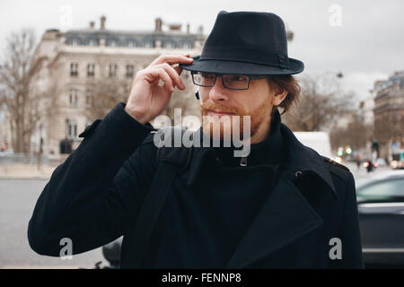 Serious Thoughtful Bearded Man Wearing Hat while Walking on the Street. Headshot Composition. Stock Photo