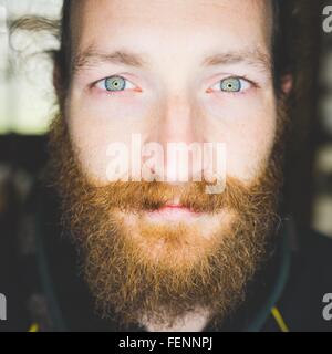 Close up portrait of bearded mid adult man looking at camera smiling Stock Photo