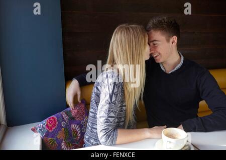 Romantic young couple face to face in cafe Stock Photo