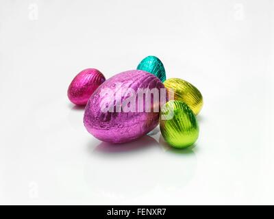 Colourful easter eggs in shiny foil on white background Stock Photo