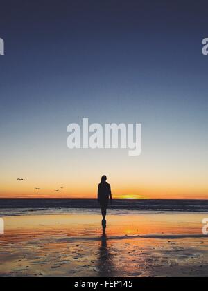 Nude woman walking on beach Stock Photo - Alamy