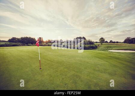 Flag in hole on golf course, Korschenbroich, Dusseldorf, Germany Stock Photo