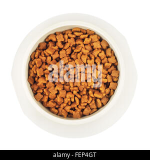 dry cat food in white bowl, isolated top view Stock Photo