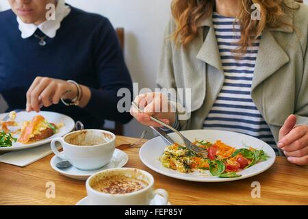 Cropped shot of women having lunch in cafe Stock Photo