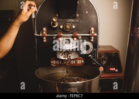 Man using coffee roaster Stock Photo