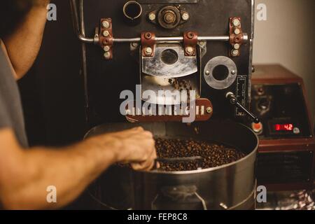 Man using coffee roaster Stock Photo