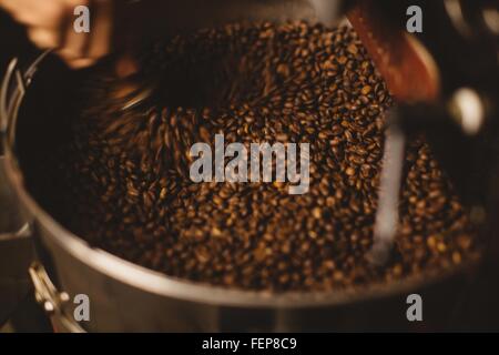 Man mixing roasted coffee beans Stock Photo