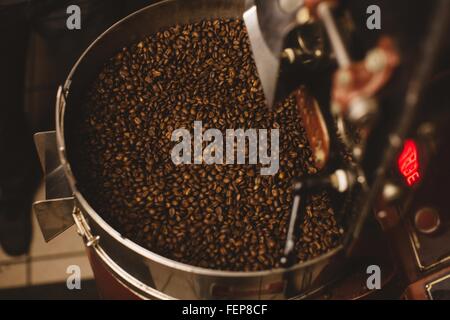 Roasted coffee beans in coffee roaster Stock Photo