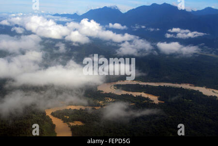 GUNUNG MULU/MALAYSIA - CIRCA NOVEMBER 2015: Aerial view of the Sungai Tutoh river and its brown muddy waters near the mountains Stock Photo