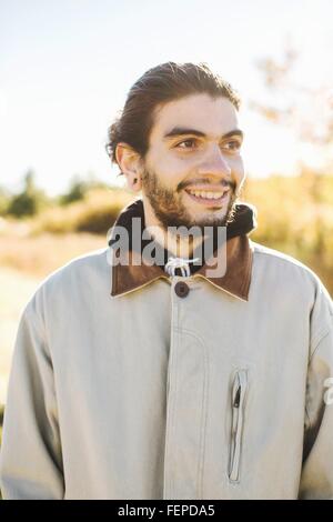 Portrait of young man, smiling, outdoors Stock Photo