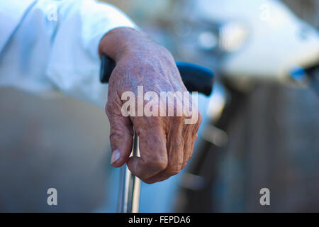 Hand of an old man on the walking stick Stock Photo
