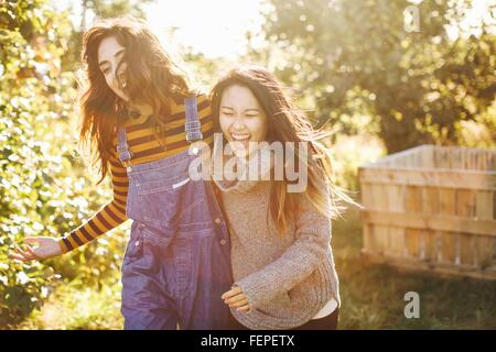 Two young women, in rural environment, laughing Stock Photo