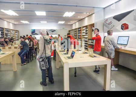 interior of Apple store in upscale Las Encantadas Shopping Center with class seated at left & several seniors browsing product Stock Photo