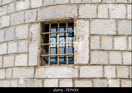Fortress wall window with iron rod Stock Photo