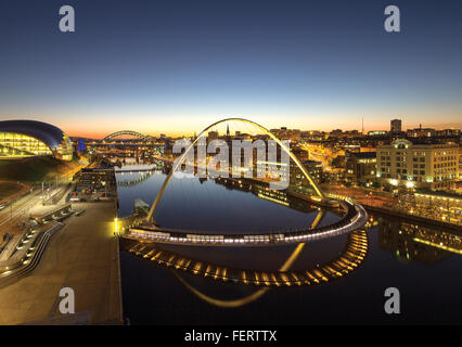 a view at dusk of Gateshead Millennium Bridge taken from the BALTIC looking across to Newcastle upon Tyne Stock Photo