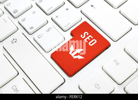 Seo business concept, red enter button or key on white keyboard photography. Stock Photo