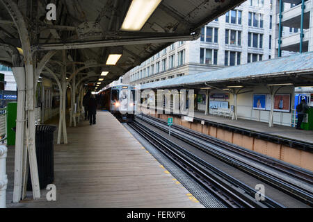 A Brown Line commuter train pulls into the 'L' Station at Randolph and Wabash in Chicago's downtown Loop. Stock Photo