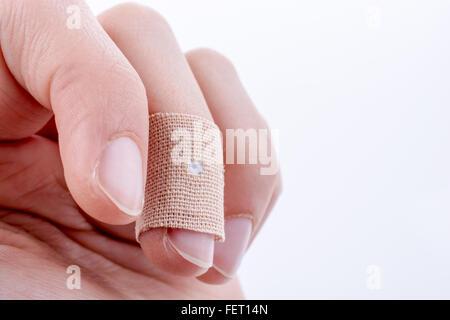 finger in white bandage on a white background Stock Photo