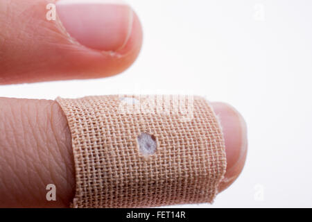 finger in white bandage on a white background Stock Photo