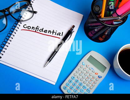 Confidential word on notepad closeup Stock Photo