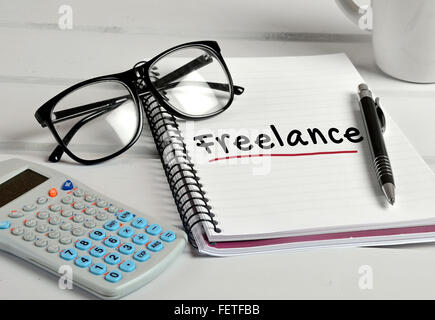 Freelance word writing on notebook Stock Photo