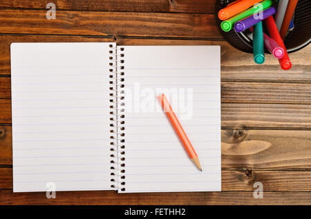 Empty notepad and box with colorful marker on table Stock Photo
