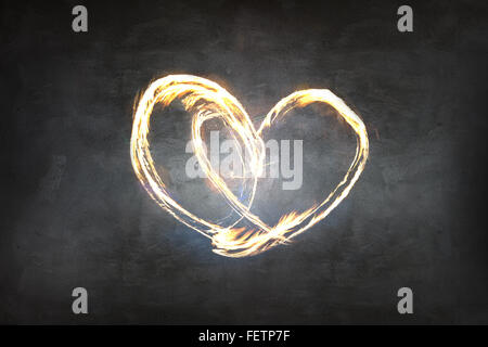 Heart symbol created by fire light Stock Photo