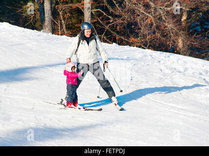 Father with a child on a ski slope in Bukovel. Bukovel is the most popular ski resort in Ukraine Stock Photo