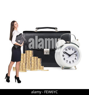 Business woman near alarm,briefcase and coins Stock Photo