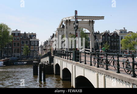 Bikes parked at Magere Brug or 'Skinny  Bridge'  across Amstel river in downtown Amsterdam, The Netherlands Stock Photo