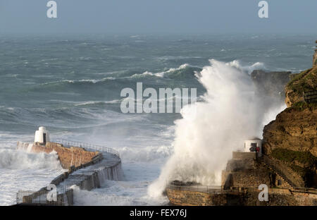 Portreath Cornwall England. Huge wave splash hitting the harbour wall and Dead Man's Hut during storm Imogen. Stock Photo