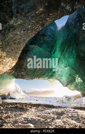 Inside ice cave looking out at Breidamerkurjokull Breiðamerkurjökull Ice Cave, Crystal Cave in Vatnajökull National Park South East Iceland in January Stock Photo