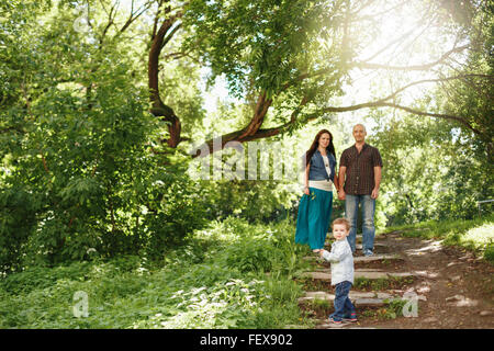 Happy Family Having Fun Outdoors. Pregnant Woman, Man and Cute Little Boy. Natural Colors. Selective Focus on a Kid.