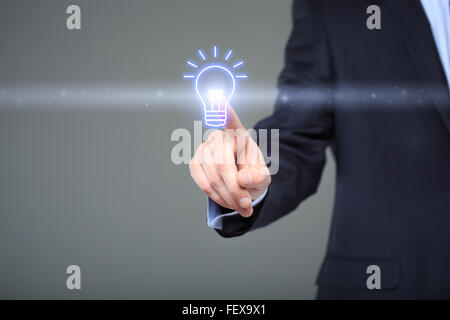 technology and internet concept - businessman pressing button with bulb on virtual screens Stock Photo