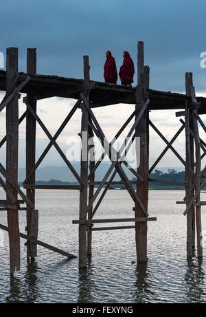 Monks crossing Taungthaman lake on the U Bein teak bridge, Amarapura ...