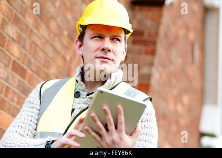 Architects discussing plans at a building site Stock Photo