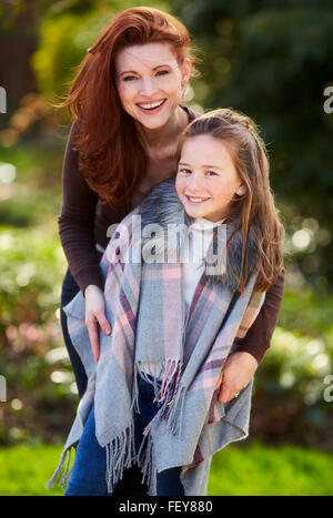 Mother and daughter stood together smiling Stock Photo