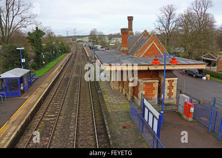 A rural train station with a really old station building and disused platform, showing a wooden canopy and leaded and slate roof Stock Photo