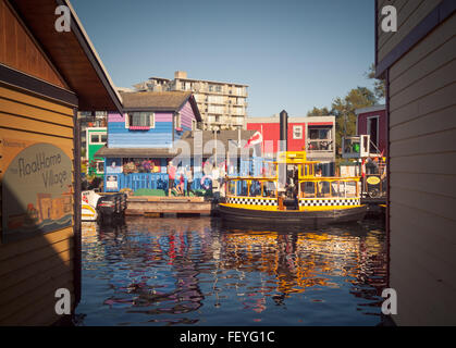 A view of a Victoria H2O Water Taxi and tourists at Fisherman's Wharf in Victoria, British Columbia, Canada. Stock Photo