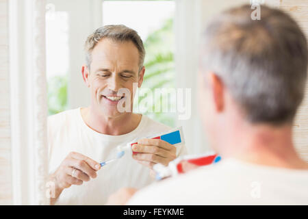 Handsome man brushing his teeth Stock Photo
