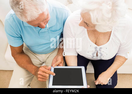 Focused senior couple using tablet Stock Photo