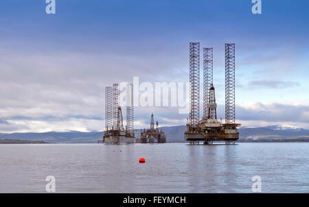 NORTH SEA OIL RIGS MONARCH AND GALAXY  ANCHORED OUTSIDE CROMARTY THE BLACK ISLE CROMARTY FIRTH WITH SNOW ON THE HILLS Stock Photo