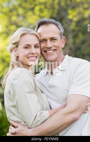 Cute couple hugging with arms around Stock Photo