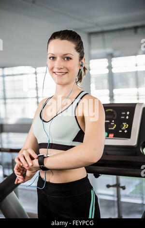 Smiling woman using smart watch Stock Photo