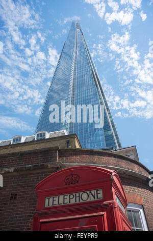The Shard in London with a traditional red telephone box in front Stock Photo