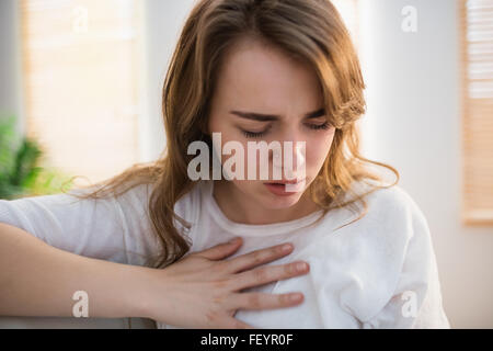 Pretty woman suffering from chest pain Stock Photo