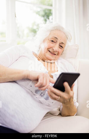Elderly woman using her smartphone Stock Photo