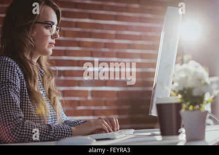 Focused hipster businesswoman watching computer Stock Photo