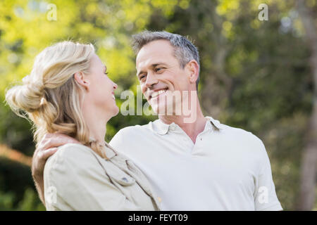 Cute couple hugging with arms around Stock Photo