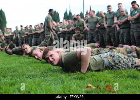 The Marines of 11th Marine Regiment prepare to go compete in a tug-of-war competition in celebration Saint Barbara's Day - the patron saint of Artillery - in Las Pulgas, Camp Pendleton, Calif., Jan. 21, 2016. The regiment remembered those artillerymen who have gone before them with a memorial service, inducted new members into the Honorable Order of Saint Barbara, and added some levity with a homemade trebuchet competition. Stock Photo